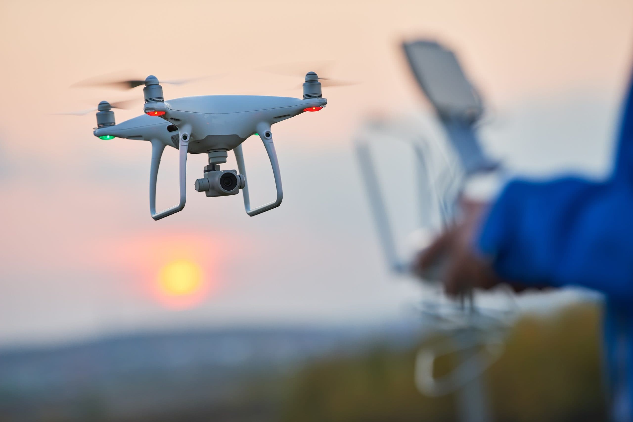 Drone flying and operated by remote control, view of the sunset